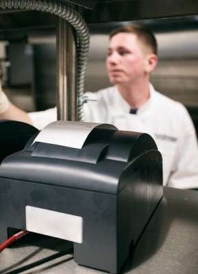 A kitchen printer with order receipt